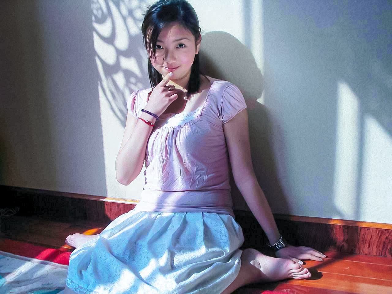 Softly lit close-up of bare foot and heel together, highlighting natural texture and graceful curve